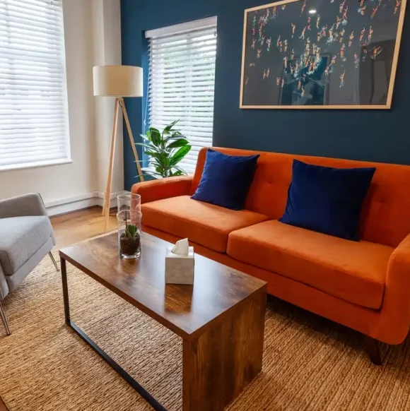 Comfortable counselling room with sofa and armchairs